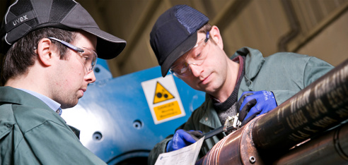 Two RMSpumptools employees installing dual electrical submersible pump (ESP) system