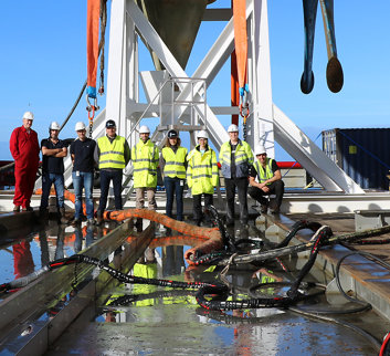Employees of James Fisher wearing Hi-Vis jackets on a vessel