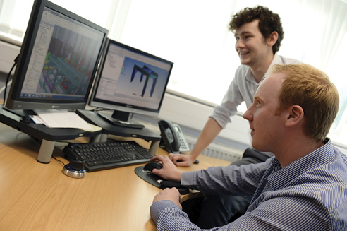 Two men looking at computer