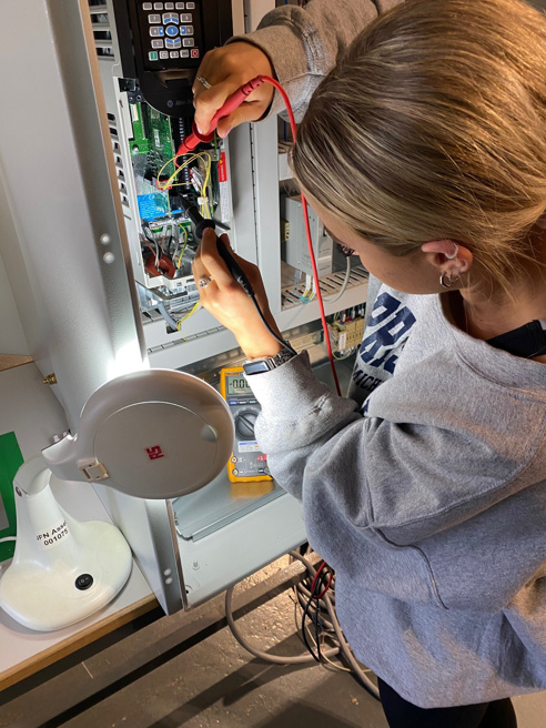 young female engineer performing electrical tests