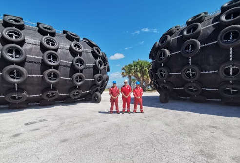 Three of Fendercare Marine's employees stood between two fenders